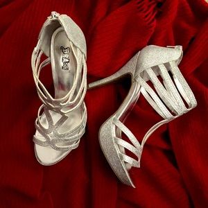 Brash woman’s silver glitter platforms